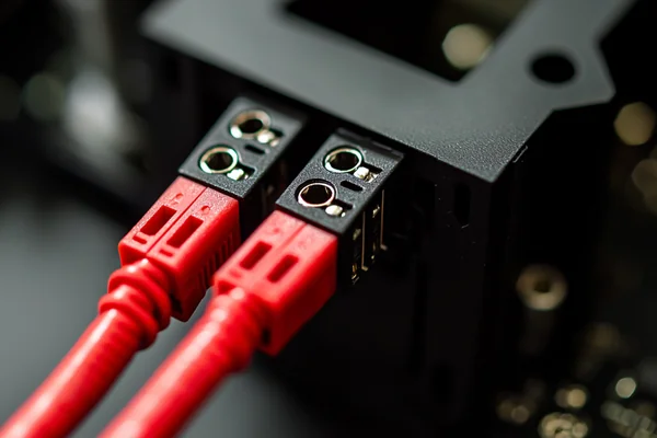 A close-up of a DC axial fan's connector wires, with red and black clearly visible