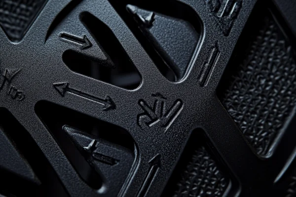 A close-up of the arrows on the side of a DC fan