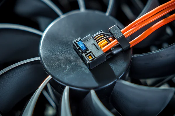 A fan with a cable caught in the blades, stopping it from spinning