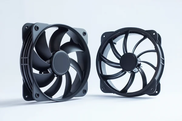 A standard fan next to a rugged, industrial-looking extended temperature fan.