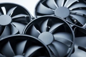 Close-up product photography of three DC axial fans with different blade counts - a 3-blade, 7-blade, and 11-blade fan - arranged side by side showing the visual difference in blade density