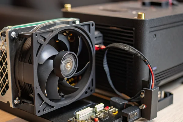 A compact, low-noise DC axial fan mounted inside a home theater projector