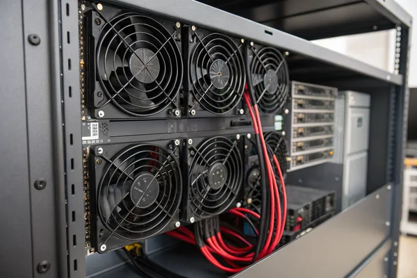A fully populated high-density network switch chassis with a visible cooling fan array