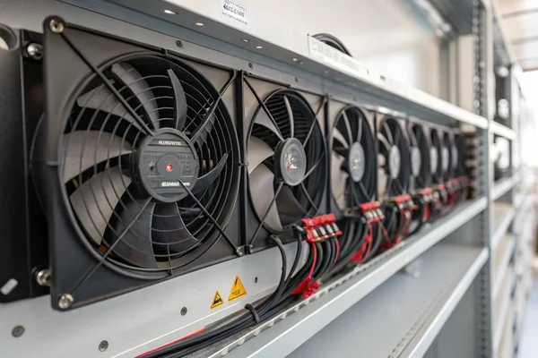 A row of DC axial fans installed in an HVAC equipment panel