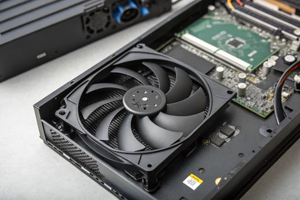 A slim, high-static-pressure DC axial fan mounted inside a gaming console chassis