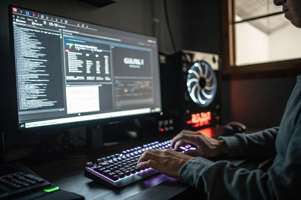Technician adjusting BIOS UEFI fan curve settings on a motherboard graphical interface screen, monitor showing a temperature-to-speed graph