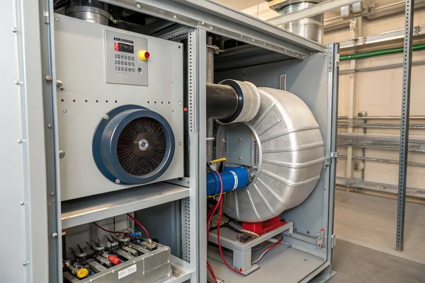 Blower fan installed inside an industrial control cabinet with visible duct outlet transition and filter panel showing the real installation geometry