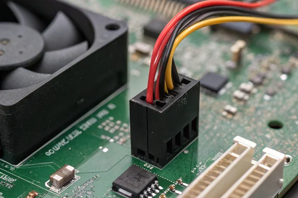 Close-up of a case fan's 4-pin PWM connector next to a CPU cooler fan's connector, both plugged into motherboard fan headers