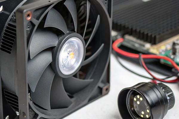 Close-up of a UHP lamp module inside a projector next to its cooling fan