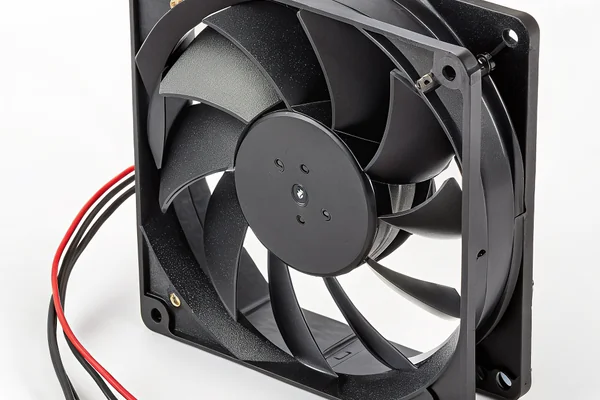 DC axial case cooling fan installed in a black aluminum chassis panel, showing blade hub and mounting screws in a real equipment enclosure