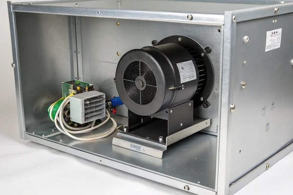 DC brushless blower mounted inside a metal industrial electronics enclosure, showing inlet clearance and outlet duct routing to a heatsink