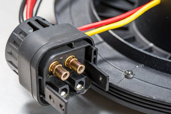 Tachometer signal wire connections on the rear housing of a DC brushless blower, showing the three-wire interface in detail