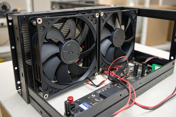 Two DC axial fans mounted side by side inside a UPS chassis showing N+1 redundant cooling configuration