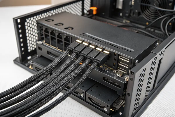 Neatly routed fan cables converging on a powered PWM hub mounted behind a PC case's motherboard tray