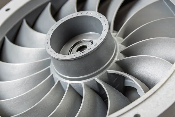 Close-up cross-section view of a forward-curved impeller blower housing showing the blade curvature direction relative to rotation