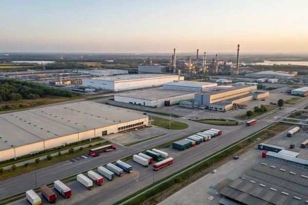 Aerial view of an industrial manufacturing district with multiple factory buildings, warehouses, and logistics infrastructure