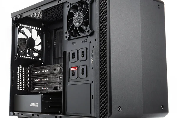 Small mini-ITX PC case with visible internal fan mounting positions, motherboard and components packed tightly inside
